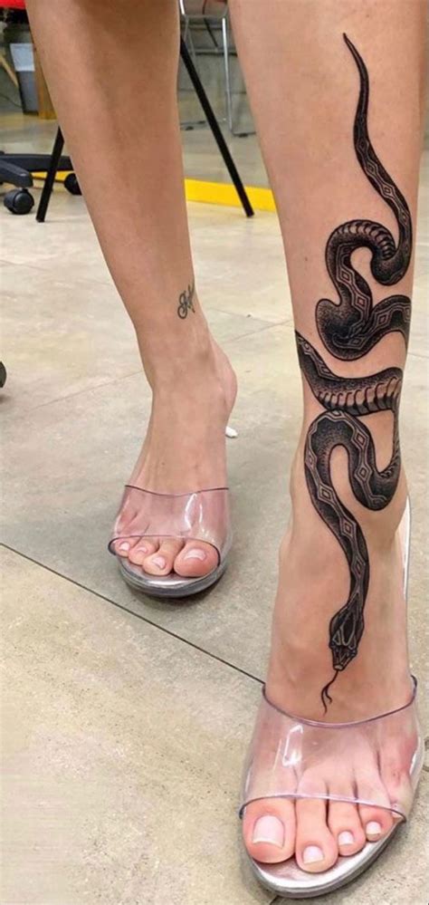 snake wrapped leg tattoo